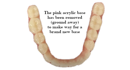 A full lower denture that has had most of its old pink acrylic base removed as one step in the process of doing a denture rebase