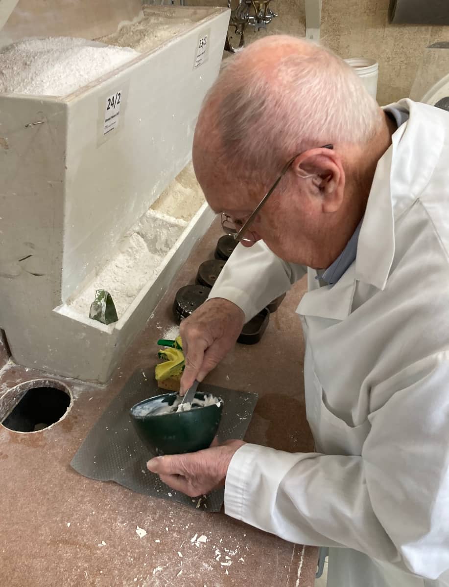 Joe Schankula at 91 mixing plaster to prepare to pour up denture models