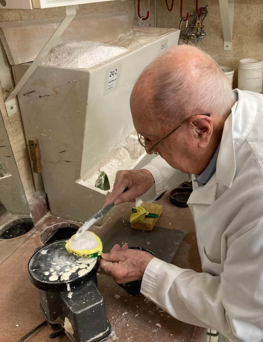 Joe Schankula at 91 using a dental vibrator to continue pouring up a denture model in a patient's impression tray