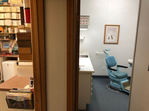 37-Shot from the waiting room doorway looking partially into both the lab on the left and the operatory with its dental chair on the right