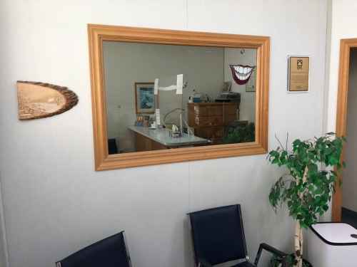 A mirror and some items on a wall in the waiting room