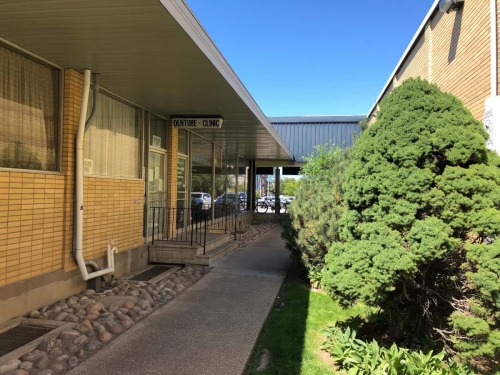 68-A patient's point of view if they had parked in the rear parking lot behind the Grantham Plaza and were continuing their walk down the garden alleyway, closer now to our overhanging Denture Clinic sign above our entrance, with the two steps up to the entrance porch